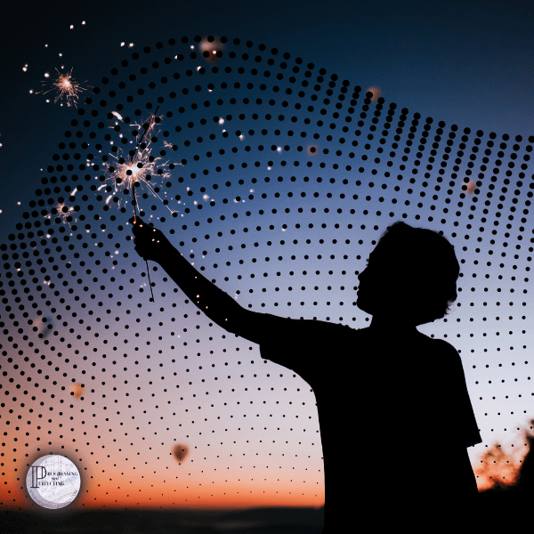 11 a silhouette of a person holding a sparkler